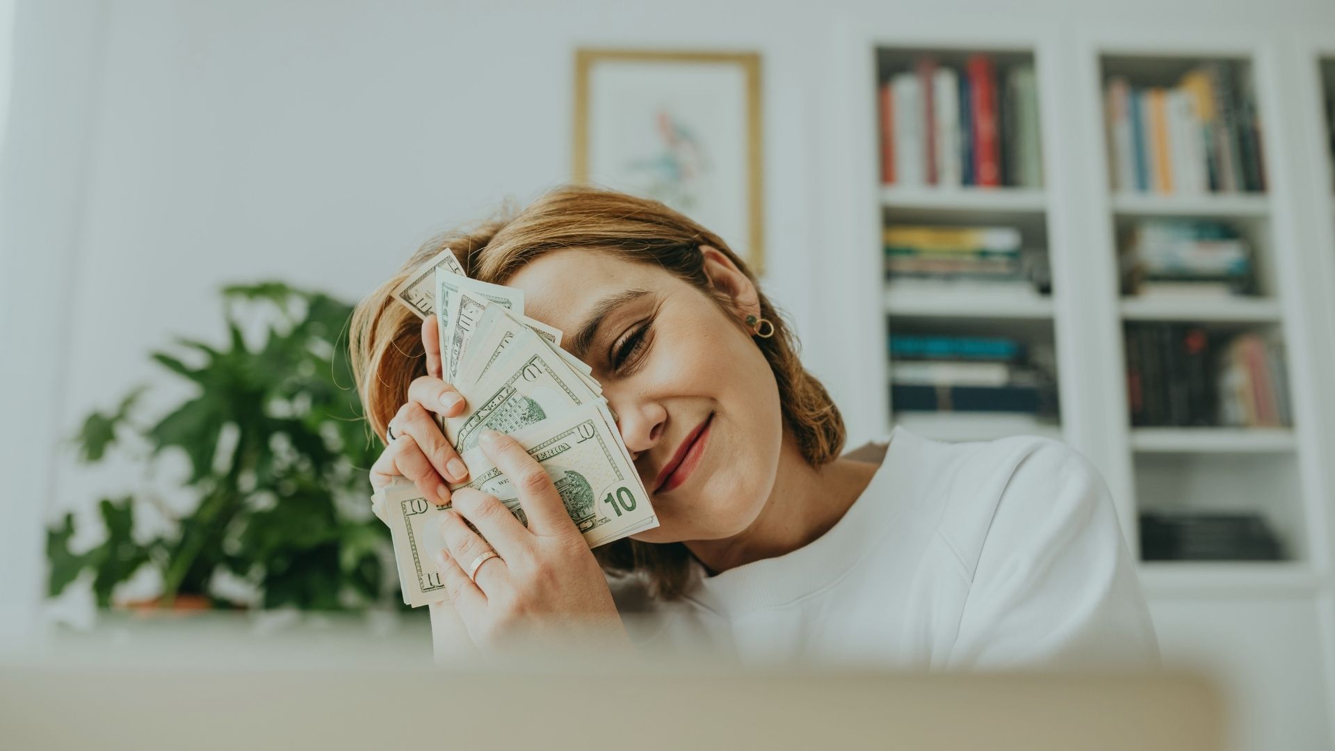woman with money pressed on her face